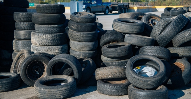 Many stacked piles of used tires