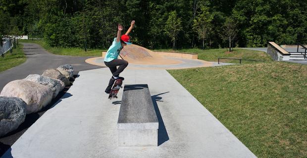 Image of skater doing a trick off the concrete sculpture.