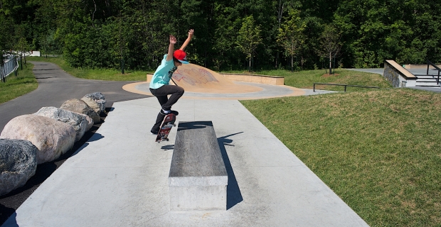 Image of skater doing a trick off the concrete sculpture.