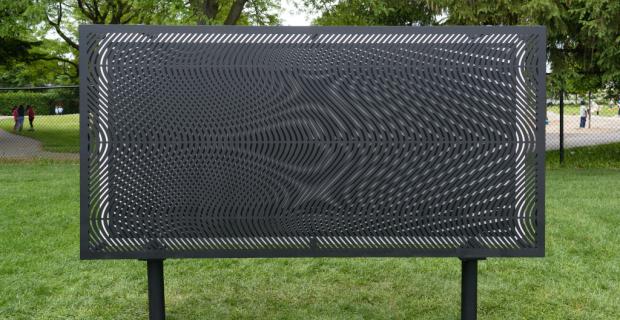 Sculpture made of four steel panels with patterns cut into them that produce the perception of movement when a viewer walks by.