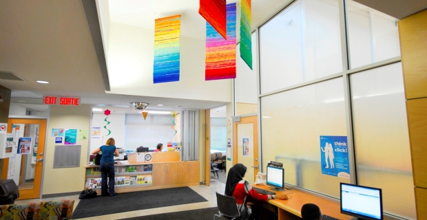 Four suspended multi-colour woven wool banners above foyer