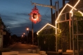 The bracket supporting the chandelier represents the branch of a Mountain Ash tree, and suspends the artwork over the dining space created by the plaza development project.