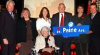 Mayor and guests holding a street sign 