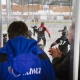 daytime image of the rink from the stands - people watching children do hockey drills