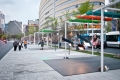 People swinging on public swings in Montreal.