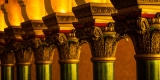 Close-up interior view of Corinthian-style columns painted green, red and gold colours in Carleton Dominion-Chalmers Centre’s main hall.  