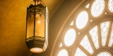 Close-up interior view of ornate lighting fixtures and arched windows in Carleton Dominion-Chalmers   Centre’s main hall.  