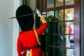 Officer with ceremonial sword banging on the door of city hall 