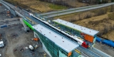 Progress photo showing workers testing a new Stadler FLIRT train at Limebank Station.