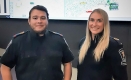 Ambulance Communications Officers Jeovani Calderon and Geneviève Taylor stand in front of digital maps of the Ottawa area at the Central Ambulance Communications Centre.