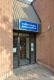 Entrance doors to Stafford Studios set inside and next to a brick wall