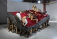 A large sculpture made of various wooden, bone-like and velvet materials.