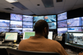 A back view of Bashir Mohamed, an Analyst with Traffic Monitoring and Signal Control Systems, as he monitors the many screens and data input sources at the City’s Traffic Control Centre.