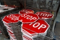 A stack of stop signs waiting to be installed.