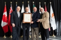 Mayor Sutcliffe presenting the proclamation to Réjean Thibault from Collège La Cité, Sylvain Charbonneau from University of Ottawa, and Louis Patrick Leroux from Saint-Paul University.