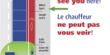 Poster showing a large truck with the blind spots for the driver marked in red along its sides.