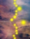 Une œuvre saisissante combinant la scanographie Polaroid et la manipulation numérique, présentant une série d'orbes jaunes lumineux sur un ciel onirique rempli de nuages.