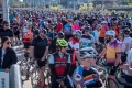 A large crowd of cyclists and CN Cycle event attendees gathered on a street.