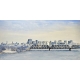 This watercolor artwork depicts a wintery skyline view of Ottawa with its iconic buildings and a steel bridge crossing the icy river in the foreground.