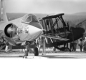 Black and white photo of a modern RCAF F-104 fighter jet and an older WWI era German plane, highlighting aviation’s evolution.