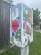 Colourful winter scenes and the word Barrhaven in a heart adorn a traffic control box