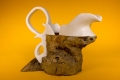 A mixed media sculpture in the shape of a jug.