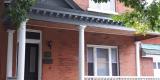 This red brick house is located at 30 James Street in the Centretown Heritage Conservation District and features a decorative front porch.