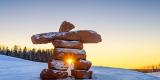 Inukshuk with dusting of snow at sunset 