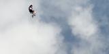 person falling through a cloud-filled sky 