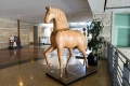 A lifesized stylized sculpture of a horse.